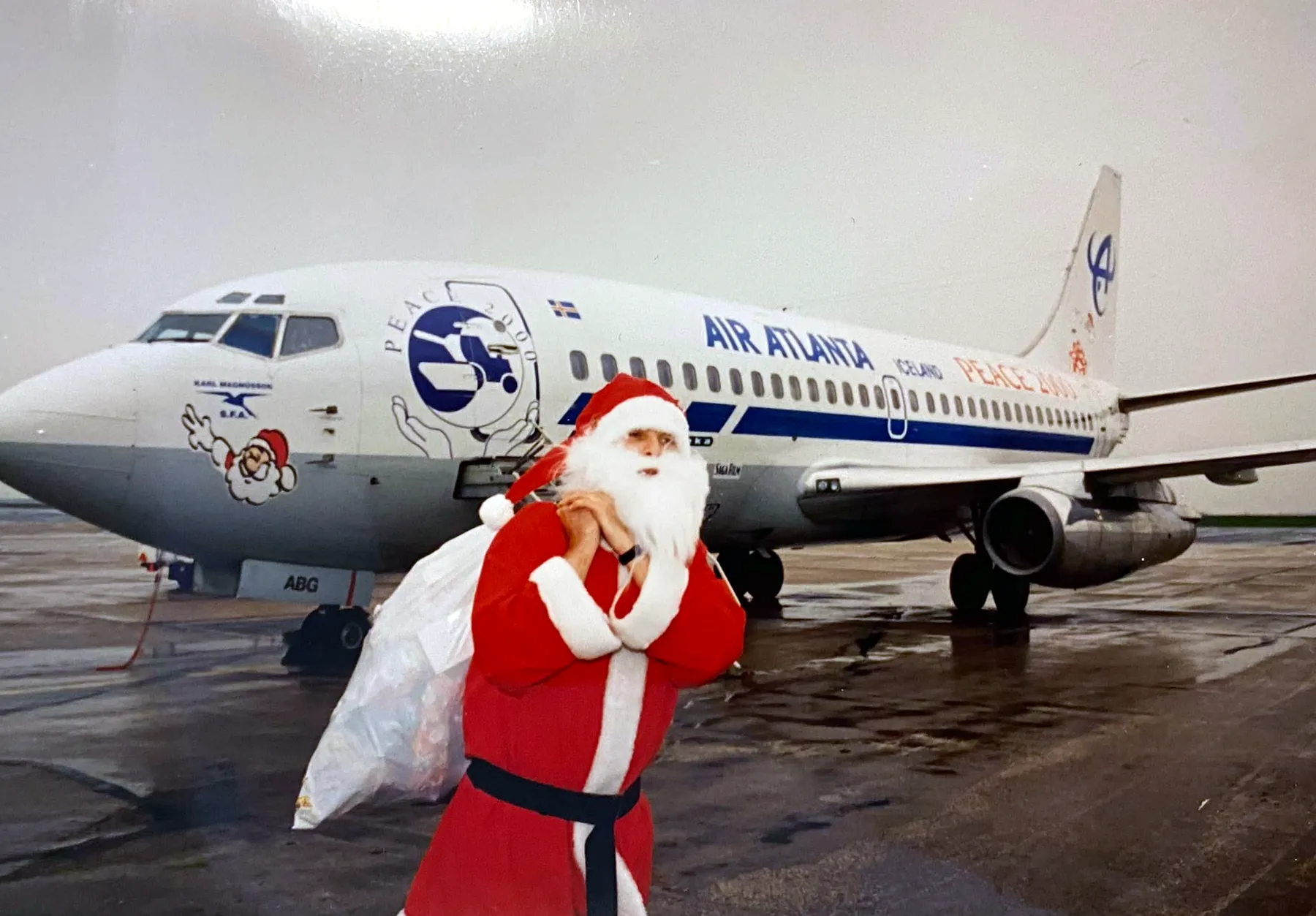 Santa with his sack in front of the Peace 2000 Boeing 737